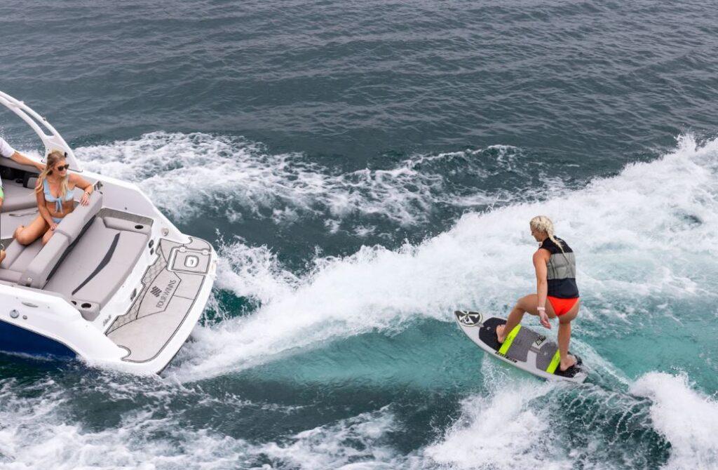 person wake boaring behind the 2023 Four Winns HD3Surf