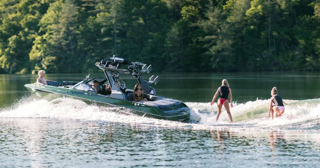 Malibu 23 MXZ with two people wake boarding behind