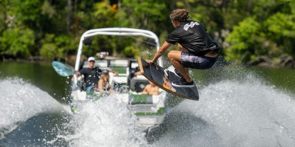 Malibu 21 LX with person doing a stunt on a wake board