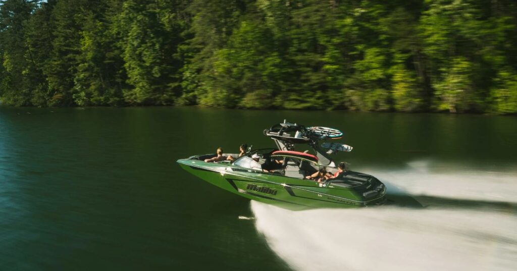 Malibu 23 MXZ with a dark forest green hull