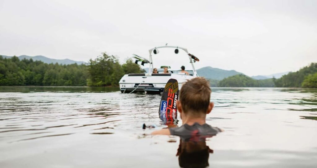 people in the water with the Malibu 20 VTX in the background