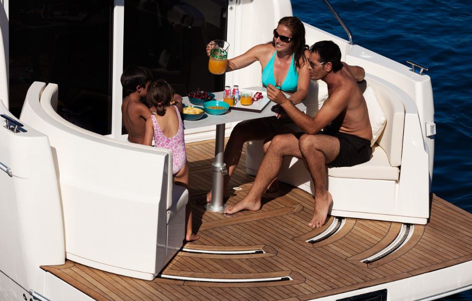 8 people sitting on out door seating area on Rodman Spirit 31′ Inboard