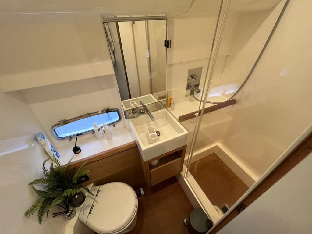 bathroom with toilet, sink and shower