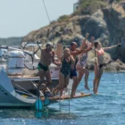 group of people jumping of the back of the Wauquiez Pilot Saloon 48e